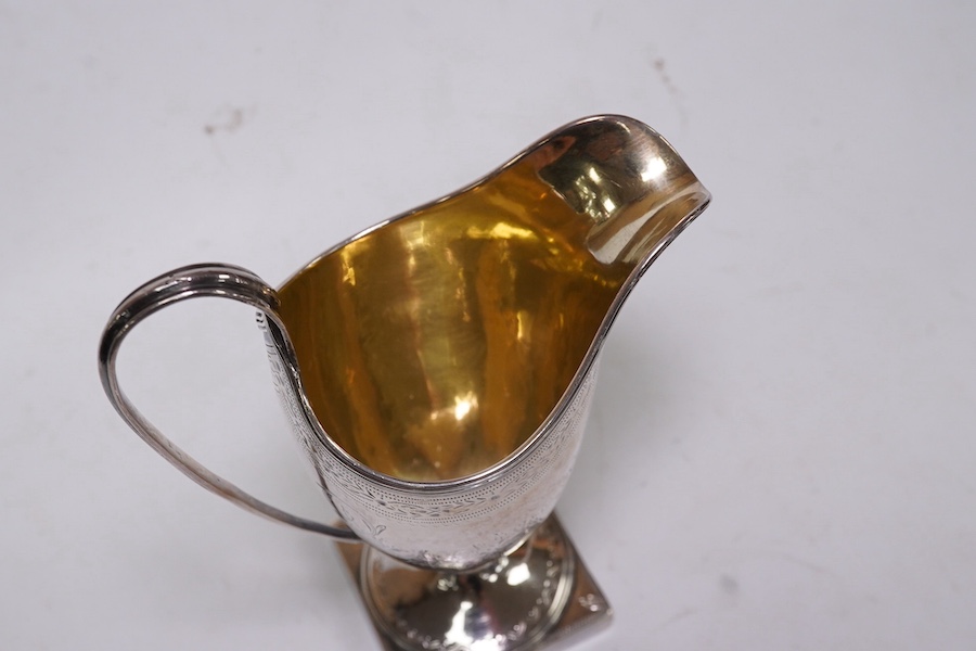 A George III silver helmet shaped cream jug by Peter & Ann Bateman, London, 1792, 14.4cm, together with two sterling menu holders. Condition - fair to good